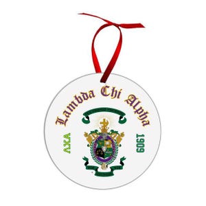 May include: A white, round Lambda Chi Alpha ornament with a red ribbon for hanging. The ornament features the fraternity's crest in green, purple, and gold, with the words "Lambda Chi Alpha" and "1909" in gold lettering.