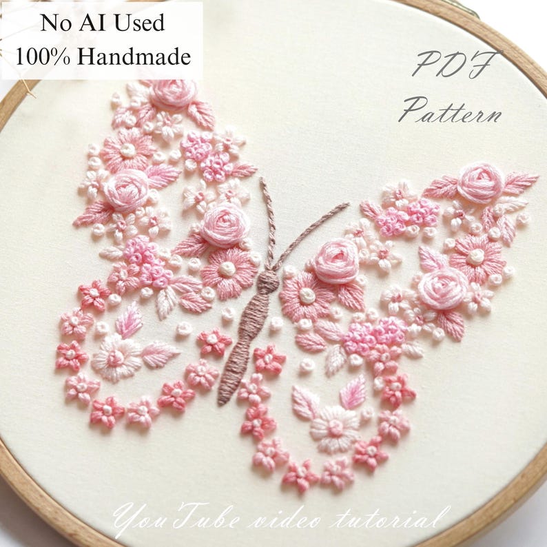 May include: An embroidered butterfly design on a hoop, featuring pink and white floral patterns. The text "No AI Used 100% Handmade" and "PDF Pattern" are visible. The words "YouTube video tutorial" are also visible. The embroidery is handmade.