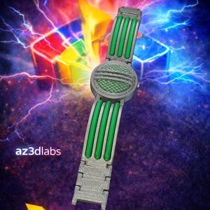 May include: A retro communicator watch with a 90s Morpher style design. The watch features a gray body with green accents and a round face. The image also includes the text "Retro Communicator Watch" and "az3dlabs".