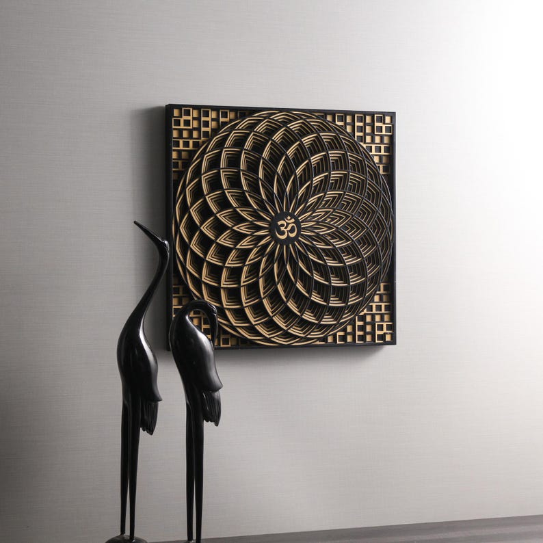 May include: Black and gold geometric wall art with a mandala design featuring the Om symbol in the center.