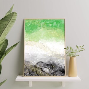 May include: Abstract art print with green, white, and black colors. The print features a layered design with gold glitter accents. The print is framed in a thin, wooden frame.