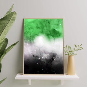 Puede incluir: Una pintura de acuarela enmarcada de una galaxia con colores verde, blanco y negro. La galaxia tiene una apariencia de nebulosa con estrellas dispersas por toda ella.