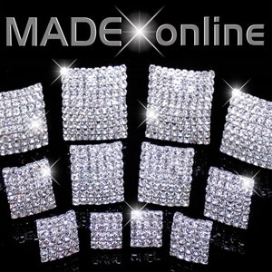 May include: Ten square-shaped rhinestone embellishments in various sizes. The rhinestones are clear and sparkle.