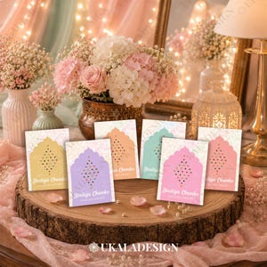 May include: Five rectangular cards with arched tops, each displaying a diamond-shaped pattern of colourful bindi stickers. The cards are coloured yellow, purple, orange, teal, and pink, featuring the text Bindiya Chamke and Umama's Mehndi.