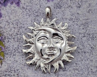 May include: Silver pendant charm featuring a detailed sun and moon design. The sun has a face with a crescent moon shape on the side.
