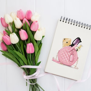 May include: A pink quilted handbag with a chain strap, a gold phone, sunglasses, and a bottle of perfume inside. The handbag is on a white background with a bouquet of pink and white tulips.