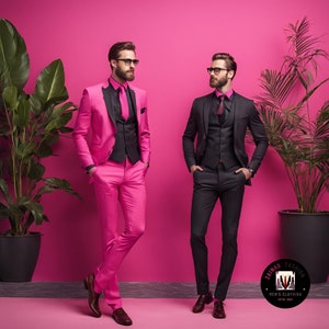 May include: Two men wearing suits stand in front of a pink background. One man is wearing a pink suit with a black vest and a black tie. The other man is wearing a black suit with a black vest and a black tie. Both men are wearing glasses. The background has a logo that says "Zainab Fashion Men's Clothing Est. 2021".