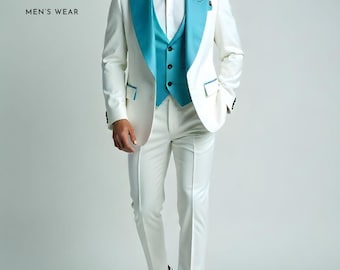 May include: A three-piece white suit with a teal lapel and vest. The suit includes a blazer, vest, and trousers. The blazer has teal accents on the pockets. The outfit is paired with a white dress shirt and white sneakers. The text "ZF CLOTHING MEN'S WEAR" is in the upper left corner.