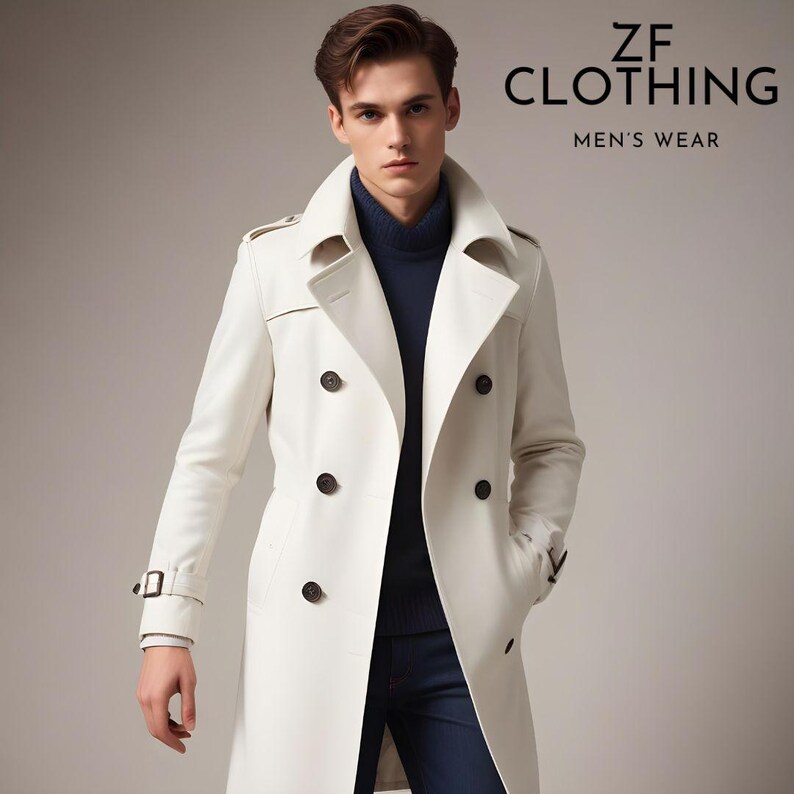 Puede incluir: Una gabardina blanca de doble botonadura con cintur&oacute;n y botones de cuero marr&oacute;n. La gabardina tiene un cuello que se puede llevar subido o bajado.  ZF CLOTHING MEN'S WEAR est&aacute; impreso en la esquina superior derecha de la imagen.