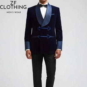 May include: A navy blue double-breasted blazer with a quilted lapel and cuffs. The blazer features decorative blue frog closures and trim. The text "ZF CLOTHING MEN'S WEAR" is visible in the upper left corner. The model is wearing a black bow tie and black pants.