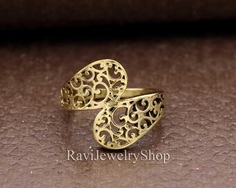 May include: Gold filigree ring with a delicate, openwork design. The ring is adjustable and can be worn on any finger.