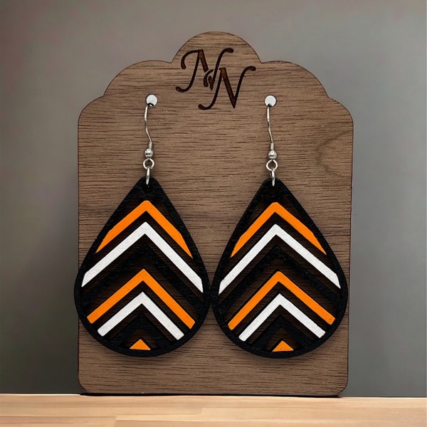 Double sided. Black, orange and white Game day wooden cutout chevron arrow earrings. Team spirit earrings. Hand cut and painted.