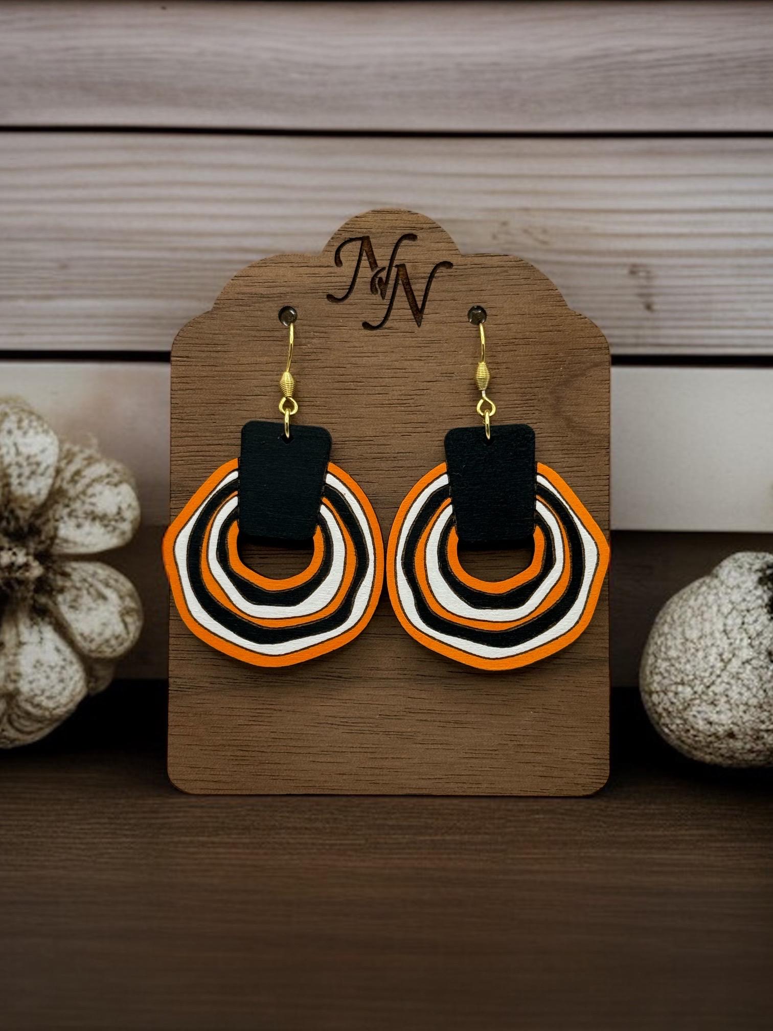 Black, orange, white Game day wooden wavy circle earrings. Team spirit. Fan gear. Fan accessories. Super lightweight. Customizable.