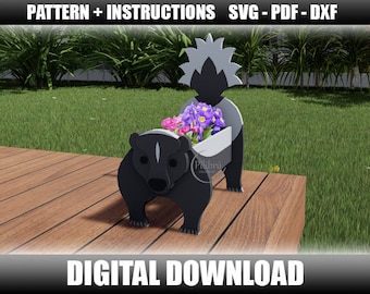 May include: A black and white wooden planter shaped like a skunk with a flower pot on its back. The planter is sitting on a wooden deck with green grass in the background. The planter has a flower pot on its back with purple and pink flowers.