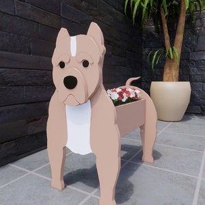 May include: A wooden planter shaped like a brown and white pit bull dog with red and white flowers in the planter.