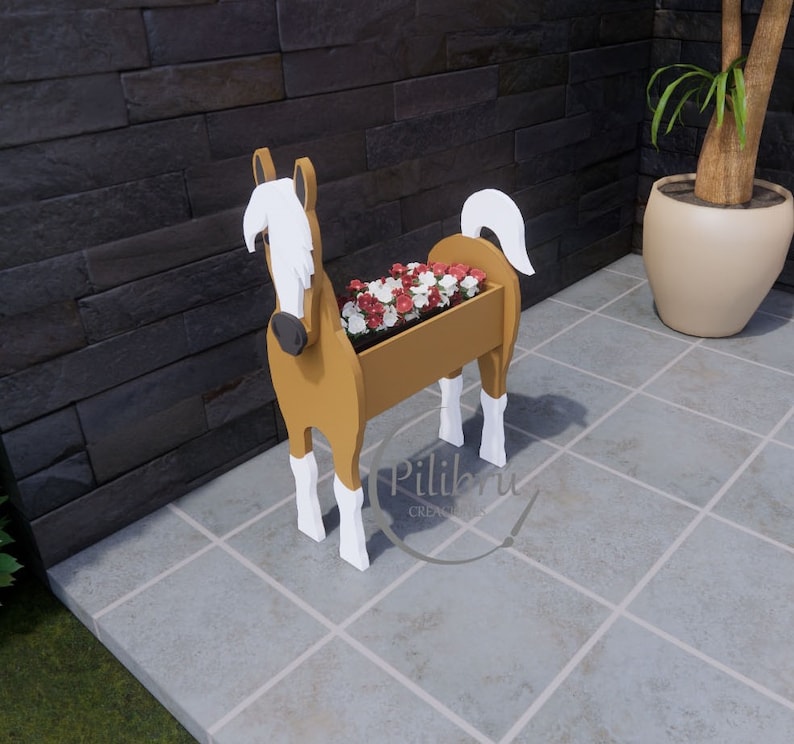 May include: A wooden horse planter with white accents. The planter is filled with red and white flowers. The horse is standing on a tiled floor.