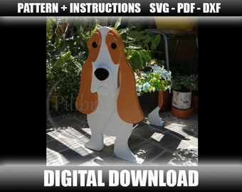 May include: A wooden planter shaped like a basset hound dog. The dog is painted white with brown ears and a brown head. The planter has a black pot inside for plants. The dog is standing on a tiled floor. The text "DIGITAL DOWNLOAD" is at the bottom of the image.