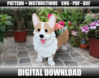 May include: A wooden planter shaped like a corgi dog. The planter is painted white with brown and tan accents. The planter is sitting on a patio with plants in the background. The text "Pilibri" is visible on the planter.