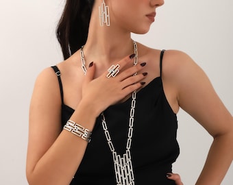 Handmade silver-plated geometric design boho necklace, bracelet, earrings, and ring.