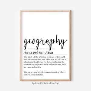 May include: A framed print featuring the word "geography" in stylish cursive. The definition of geography is displayed beneath in a clear font. The print is set against a white backdrop, within a light wood-toned frame, suitable for home decor.