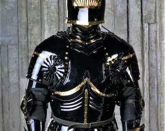 May include: A black and gold knight's armor with a helmet featuring golden wings. The armor is detailed with gold accents and rivets.