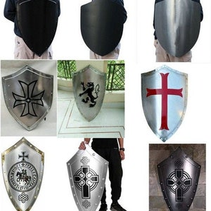 May include: A collection of nine medieval-style shields with various designs. The shields are made of metal and feature a variety of designs, including crosses, lions, and other heraldic symbols. Some shields are plain, while others are decorated with intricate details.