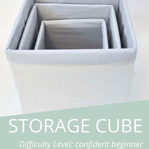 May include: A set of three gray storage cubes with white polka dots. The cubes are nested inside each other. The text "STORAGE CUBE" is written in white on a light green background. The text "Difficulty Level: confident beginner" is written below the title.