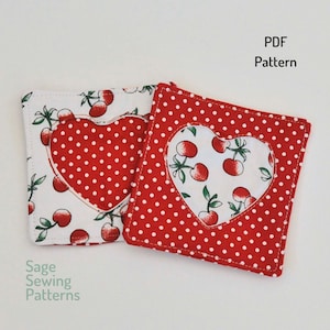 May include: Two red and white fabric coasters with a heart-shaped cutout. The heart is filled with a white fabric with red polka dots and a cherry print. The text "PDF Pattern" is in the upper right corner of the image.