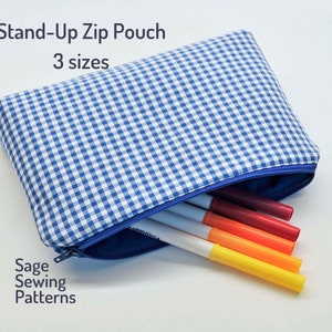 May include: A blue and white gingham stand-up zip pouch with a blue zipper. The pouch is filled with colorful markers. The text "Stand-Up Zip Pouch" and "3 sizes" is printed above the pouch. The text "Sage Sewing Patterns" is printed below the pouch.