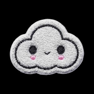 May include: A white cloud-shaped embroidered patch with a textured, fuzzy surface. The design features two round black eyes, a small black stitched mouth, and two circular pink cheeks, all outlined with a thick black embroidered border.