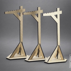 May include: Three wooden display stands with a triangular base and a horizontal crossbar. The stands are made of light brown wood with black accents.