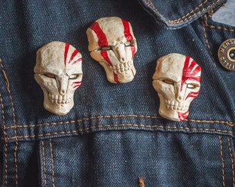 Hollow mask inspired badges and fridge magnets