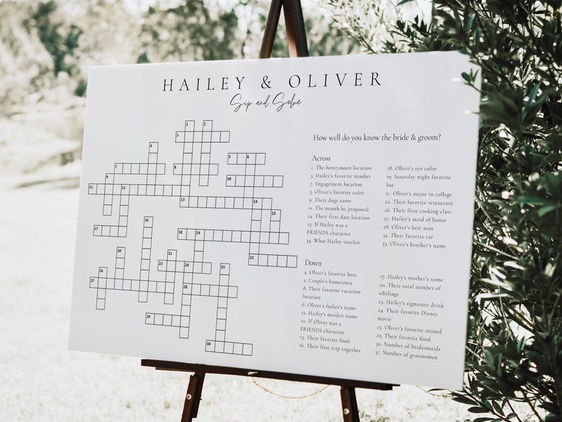 May include: A white crossword puzzle on an easel with the title "Hailey & Oliver" and the text "How well do you know the bride & groom?"  The crossword puzzle has 35 clues, with 17 across and 18 down.