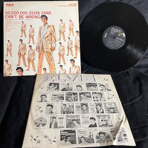 May include: A black vinyl record with a white label that says "RCA Victor" and "Elvis Gold Records - Volume 2". The album cover features a collage of Elvis Presley in a gold suit. The album cover text reads "50,000,000 Elvis Fans Can't Be Wrong".