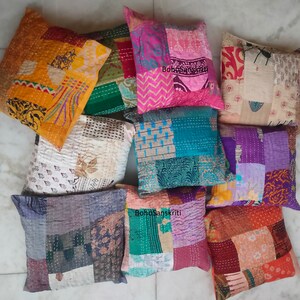 May include: A collection of nine colorful patchwork pillow covers with various patterns and textures. The pillow covers are made from recycled saris and are perfect for adding a touch of bohemian style to any room.