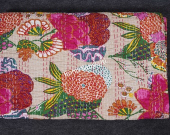 May include: A beige floral quilt with a vibrant design. The quilt features large, stylized flowers in shades of pink, orange, green, and blue, stitched with white thread. The overall dimensions are approximately 60 inches by 80 inches.