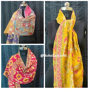 May include: Three colourful kantha quilts, each folded into a scarf shape, with a floral pattern. The quilts are made from recycled saris and are a traditional Indian craft.