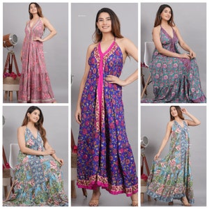 May include: Four women wearing different floral print maxi dresses with halter necklines. The dresses have a layered design and are made of a lightweight fabric.