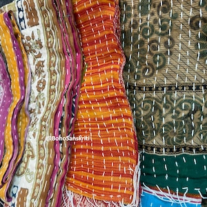 May include: A stack of colourful fabric scraps with intricate embroidery and stitching. The fabric is a mix of cotton and silk, and the colours are vibrant and rich. The fabric is perfect for quilting, patchwork, or other craft projects. @BohoSanskriti