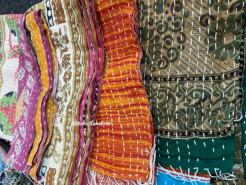 May include: A stack of colourful fabric scraps with intricate embroidery and stitching. The fabric is a mix of cotton and silk, and the colours are vibrant and rich. The fabric is perfect for quilting, patchwork, or other craft projects. @BohoSanskriti