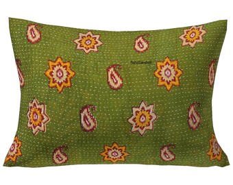 May include: Green rectangular pillow with a repeating pattern of embroidered star and paisley shapes in yellow, red, and white. The pillow has a quilted texture and the text "BohoSanskruti" is visible.