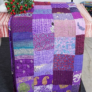 May include: A purple and blue patchwork quilt with a variety of patterns. The quilt is made of silk and is hand-stitched. It is a beautiful and unique piece of art.