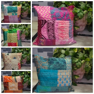 May include: Six colorful patchwork pillow covers with kantha embroidery. The pillow covers are made of recycled saris and feature a variety of colors and patterns. The pillow covers are all square and have a fringe border. The pillow covers are all handmade and unique.