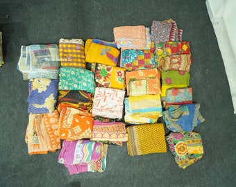 May include: A collection of colorful kantha quilts, featuring a variety of patterns and designs. The quilts are made from recycled saris and are perfect for adding a touch of bohemian style to any home.