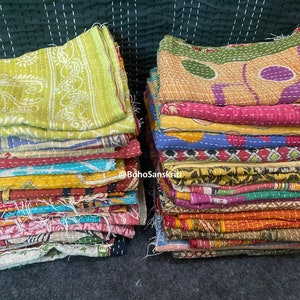 May include: Two stacks of colourful kantha quilts, each with a different pattern. The quilts are made from recycled saris and are hand-stitched. The top quilt in each stack has a light green and white pattern, while the bottom quilt in each stack has a dark brown and orange pattern. @BohoSanskruti