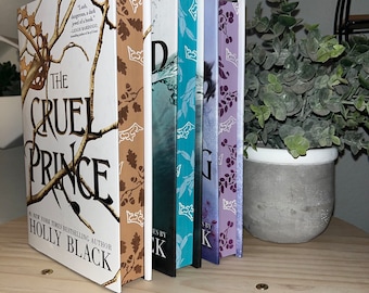May include: A set of six paperback books with colorful covers featuring floral designs. The first book is titled "The Cruel Prince" by Holly Black. The other books are titled "The Wicked King", "The Queen of Nothing", "The Cruel Prince", "The Wicked King", and "The Queen of Nothing".