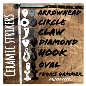 May include: Ceramic strikers in various shapes, including arrowhead, circle, claw, diamond, hook, oval, and Thor's hammer. The shapes are black and white, arranged on a wooden surface with a ruler for scale. Text on the left reads "CERAMIC STRIKERS".