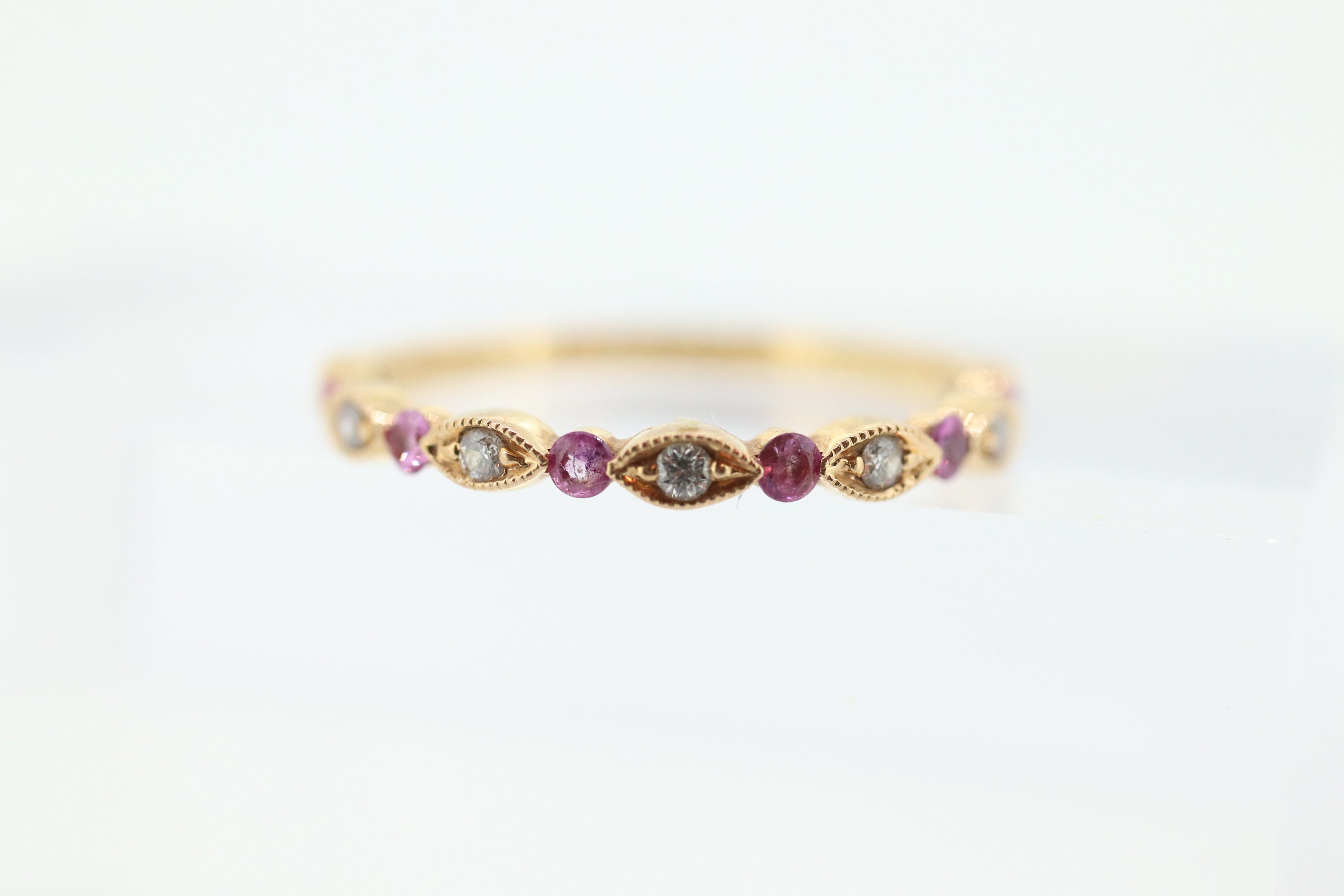 DAUSSI 18k Anniversary Pink Sapphires Diamond Ring. Henri Daussi 18k gold ring with round sapphires and diamond accents eternity band.