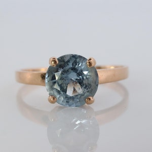 10k Aquamarine Topaz Solitaire Ring. 10k Yellow Gold Band Ring.