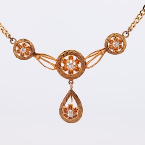Diamond pendant lavaliere. 14k Gold with a diamond set buttercup necklace. Figaro Chain necklace. Balestra